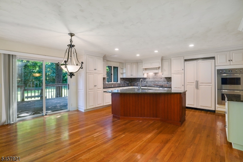 22 Court Road Morris Plains, NJ 07950 - Photo 9 of 28 a kitchen with stainless steel appliances granite countertop a refrigerator a stove top oven and a large window with wooden floor