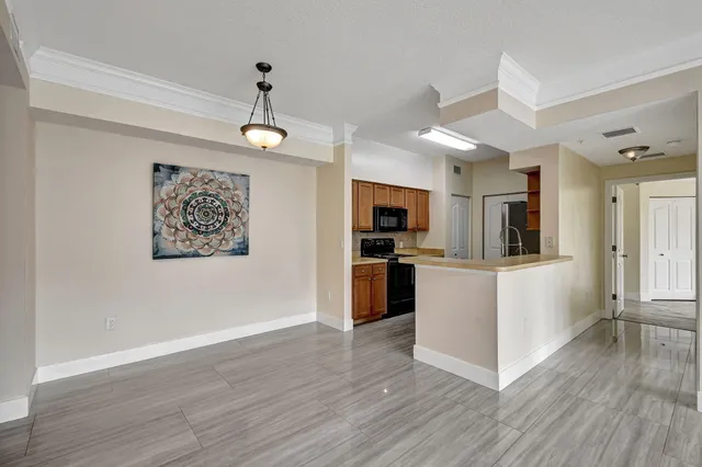a view of a kitchen with a sink a refrigerator and wooden floor