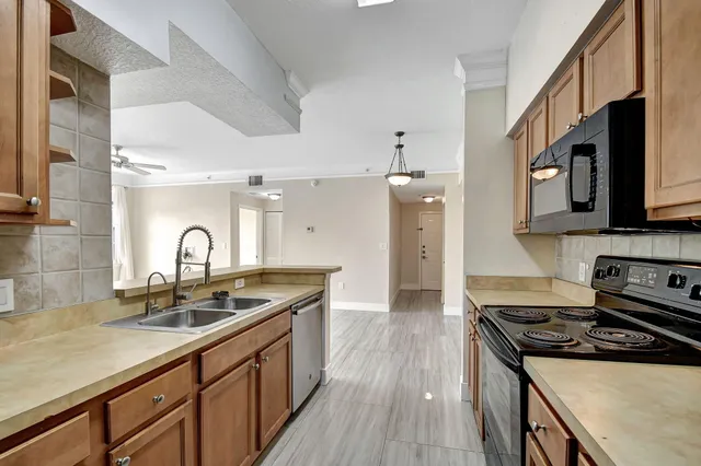 a kitchen with a white cabinets and a refrigerator