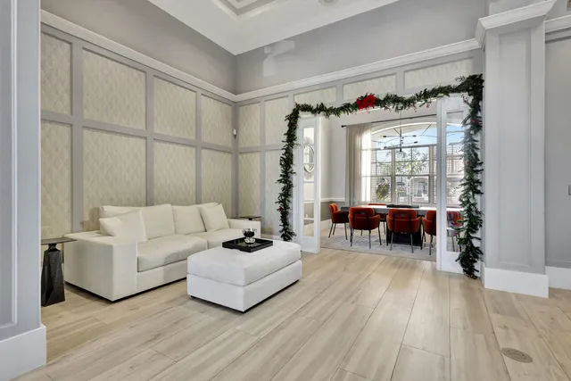 a view of a livingroom with lounge chair and a large window