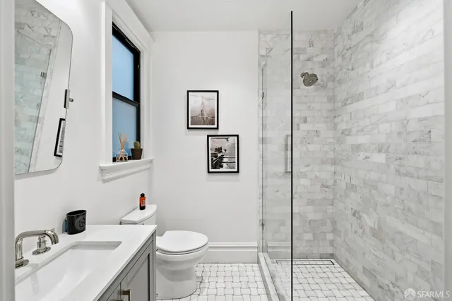 a bathroom with a toilet sink and shower