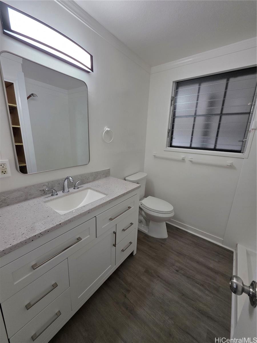 45-557 Keaahala Road, Unit K Kaneohe, HI 96744 - Photo 14 of 20 a bathroom with a granite countertop sink mirror and toilet