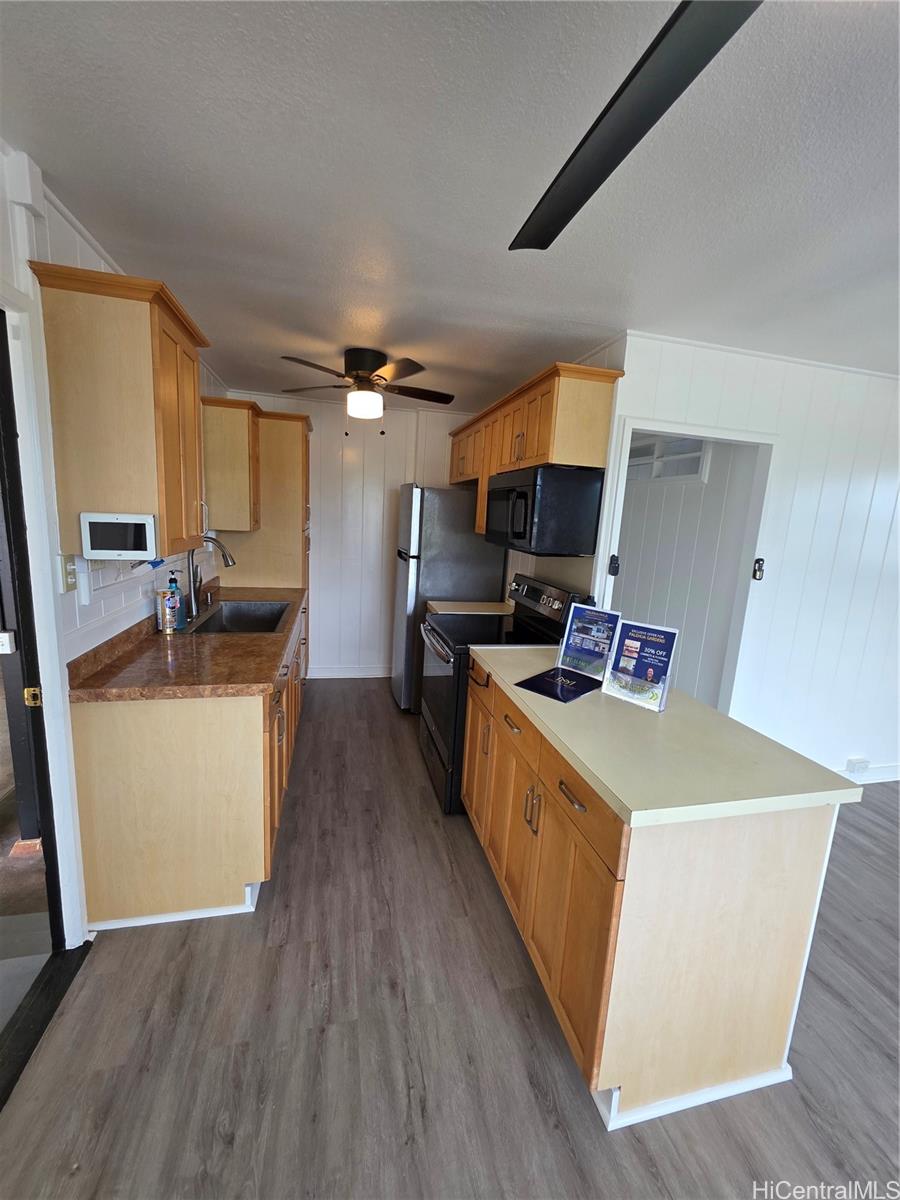 45-557 Keaahala Road, Unit K Kaneohe, HI 96744 - Photo 5 of 20 a kitchen with sink a stove top oven and refrigerator