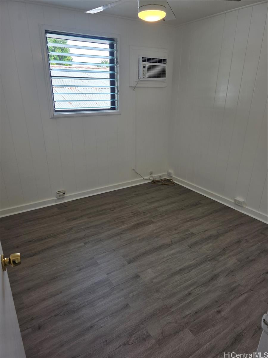 45-557 Keaahala Road, Unit K Kaneohe, HI 96744 - Photo 7 of 20 an empty room with wooden floor and windows