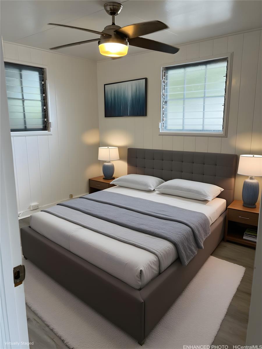 45-557 Keaahala Road, Unit K Kaneohe, HI 96744 - Photo 8 of 20 a bedroom with a bed and a flat screen tv