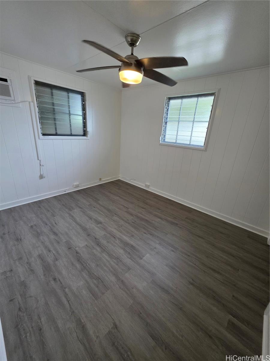 45-557 Keaahala Road, Unit K Kaneohe, HI 96744 - Photo 9 of 20 an empty room with wooden floor and windows