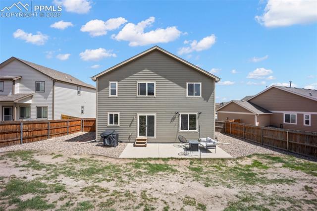 7148 Red Cardinal Loop Colorado Springs, CO 80908 - Photo 43 of 50 Rear view of house featuring a patio, entry steps, and a fenced backyard