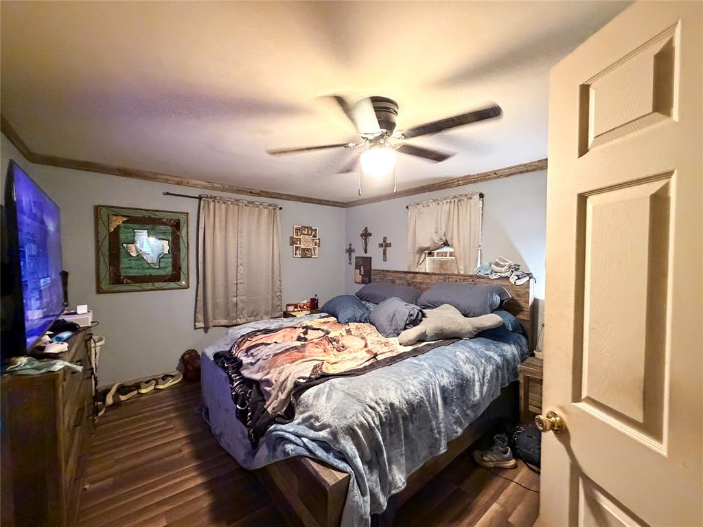 506 North Ave B Haskell, TX 79521 - Photo 7 of 13 a bedroom with a bed and a chandelier