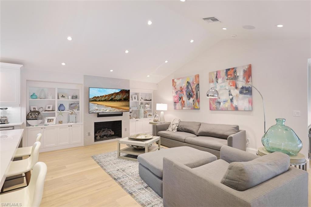 549 Neapolitan Way Naples, FL 34103 - Photo 11 of 35 a living room with furniture and a fireplace