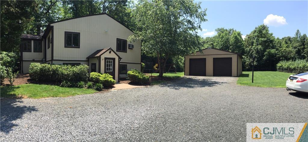 230 Deans Rhode Hall Road Monroe Township, NJ 08831 - Photo 1 of 11 a front view of a house with yard and green space