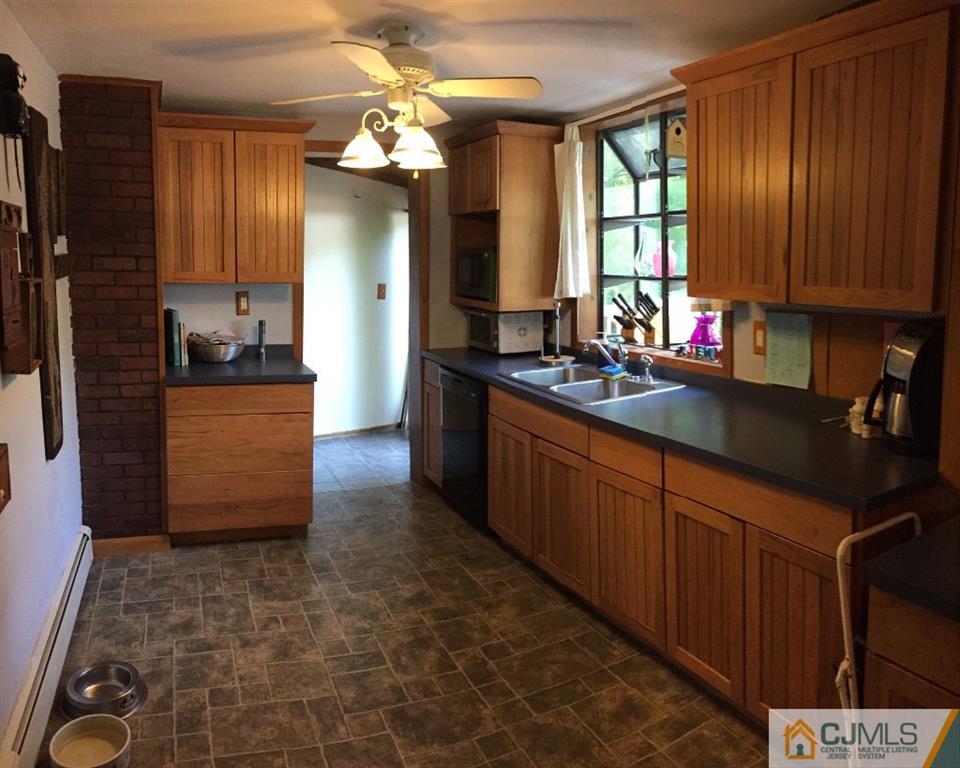 230 Deans Rhode Hall Road Monroe Township, NJ 08831 - Photo 3 of 11 a kitchen with stainless steel appliances granite countertop a sink and cabinets