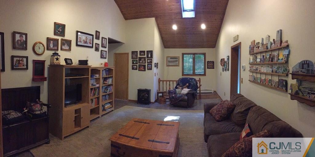 230 Deans Rhode Hall Road Monroe Township, NJ 08831 - Photo 4 of 11 a living room with furniture cabinets and a table