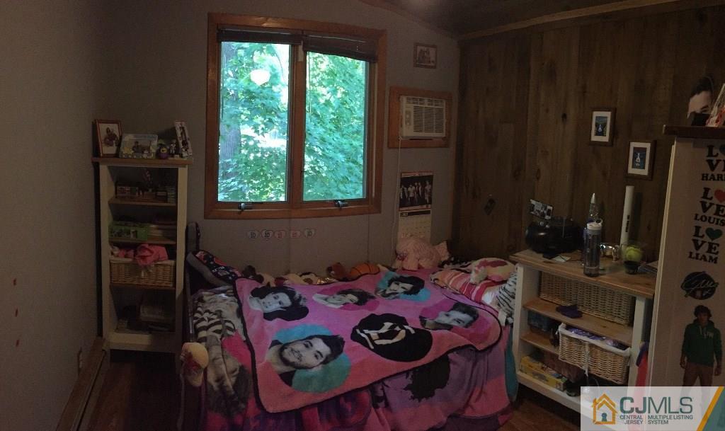 230 Deans Rhode Hall Road Monroe Township, NJ 08831 - Photo 7 of 11 a bedroom with a bed a dresser and a window