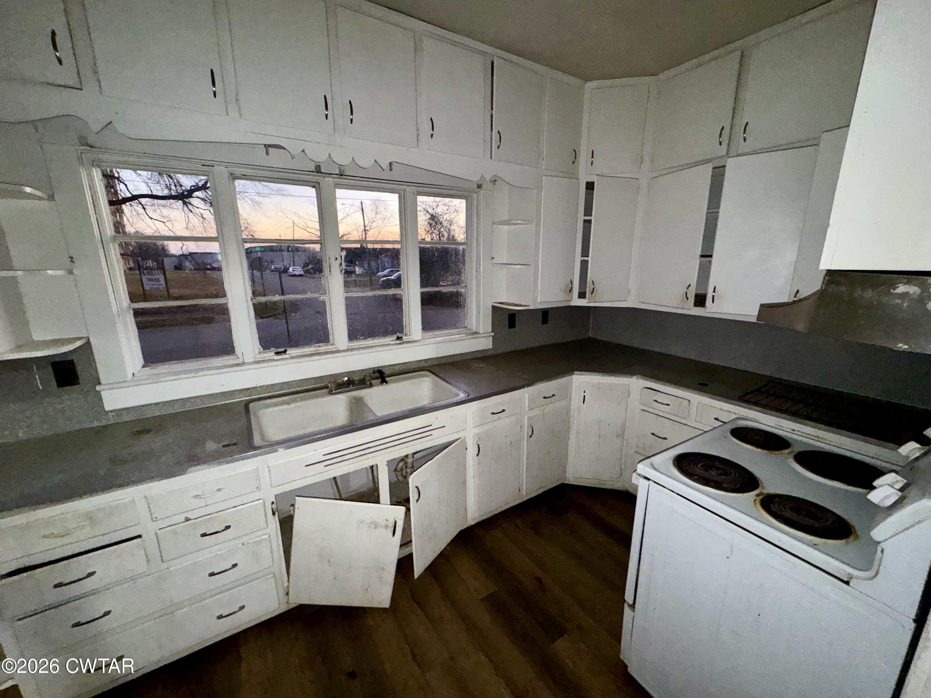 127 South Fairgrounds Street Jackson, TN 38301 - Photo 11 of 23 a kitchen with granite countertop white cabinets and white appliances