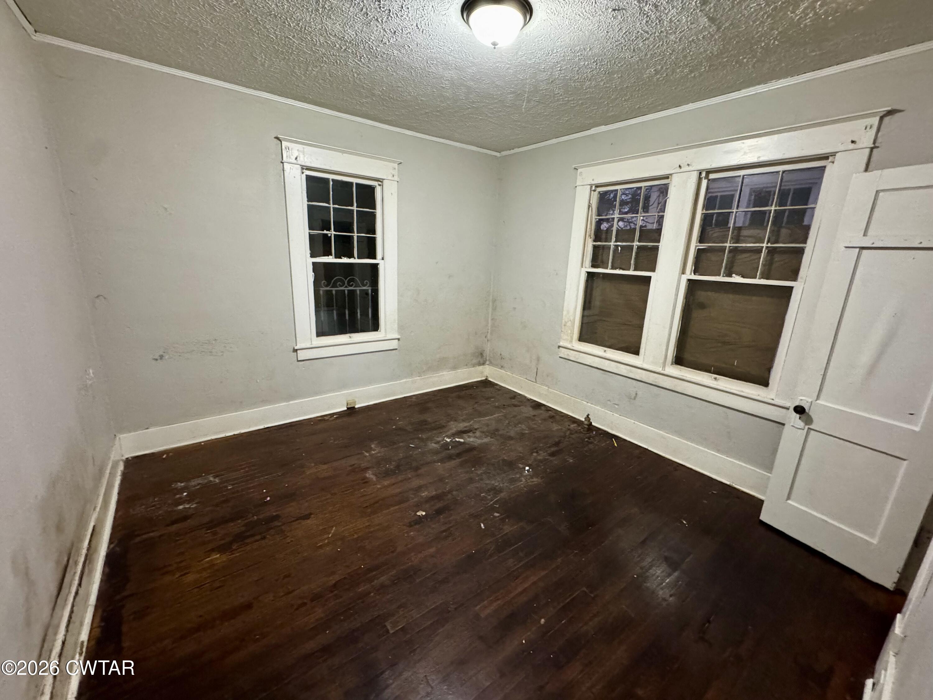 127 South Fairgrounds Street Jackson, TN 38301 - Photo 15 of 23 an empty room with wooden floor and windows