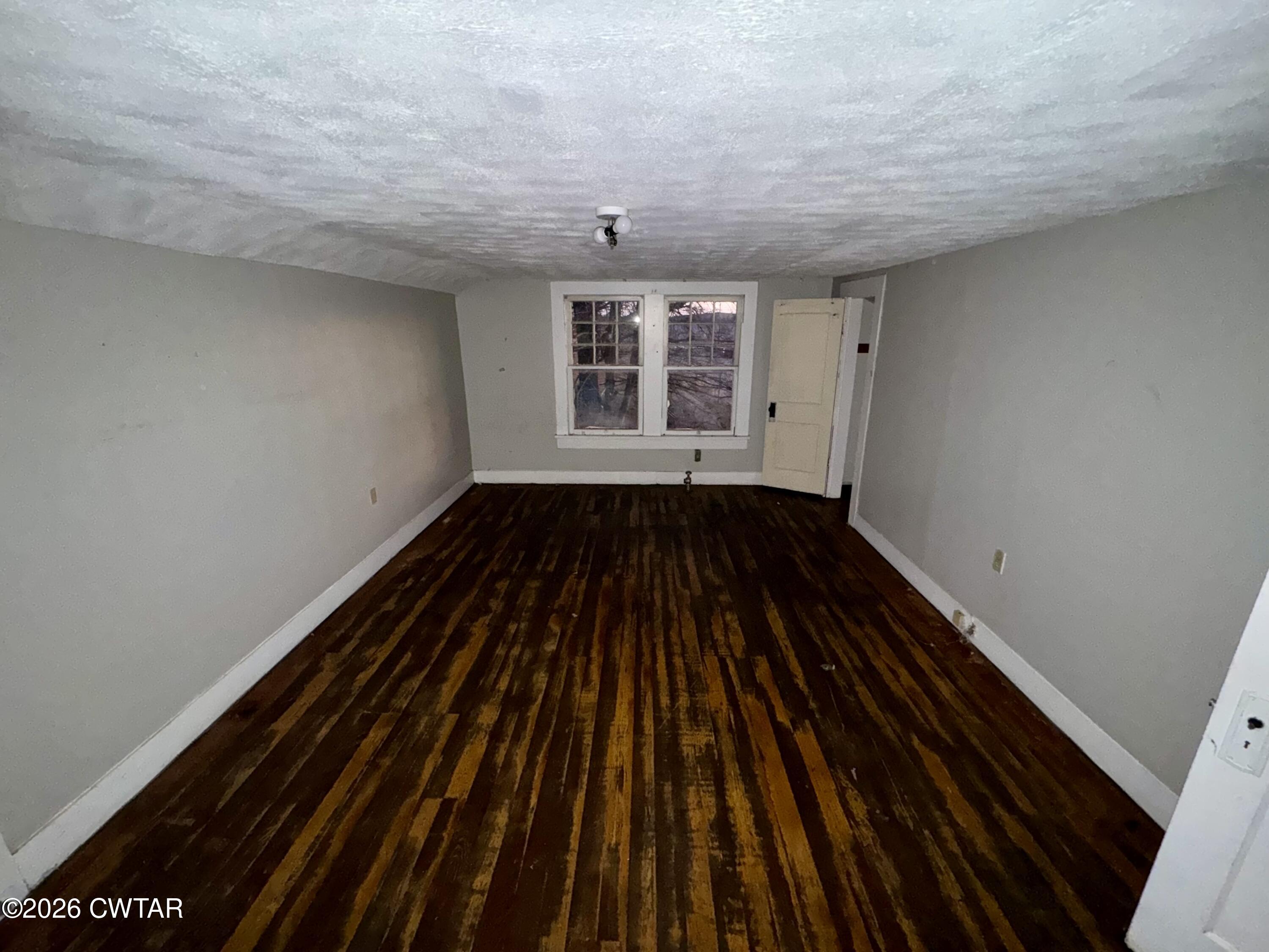 127 South Fairgrounds Street Jackson, TN 38301 - Photo 23 of 23 a view of an empty room with wooden floor and a window