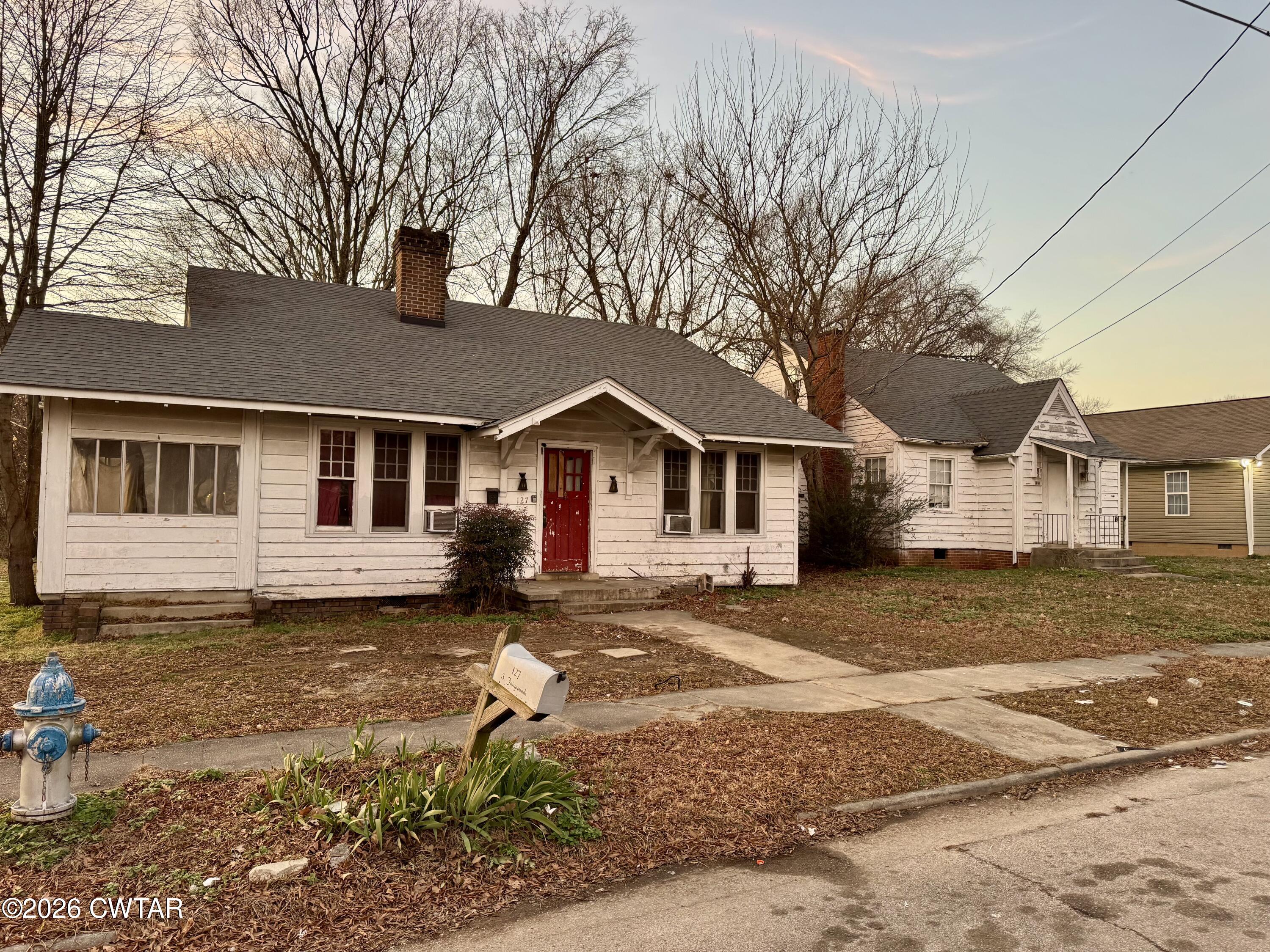 127 South Fairgrounds Street Jackson, TN 38301 - Photo 6 of 23 a front view of a house with a yard