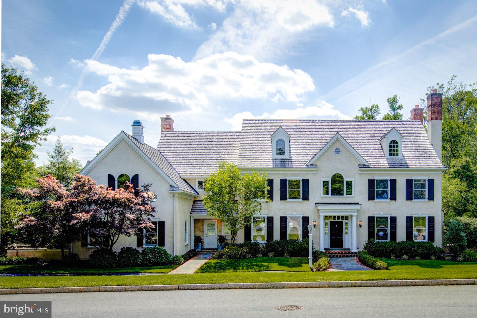 a front view of a house with a yard and potted plants