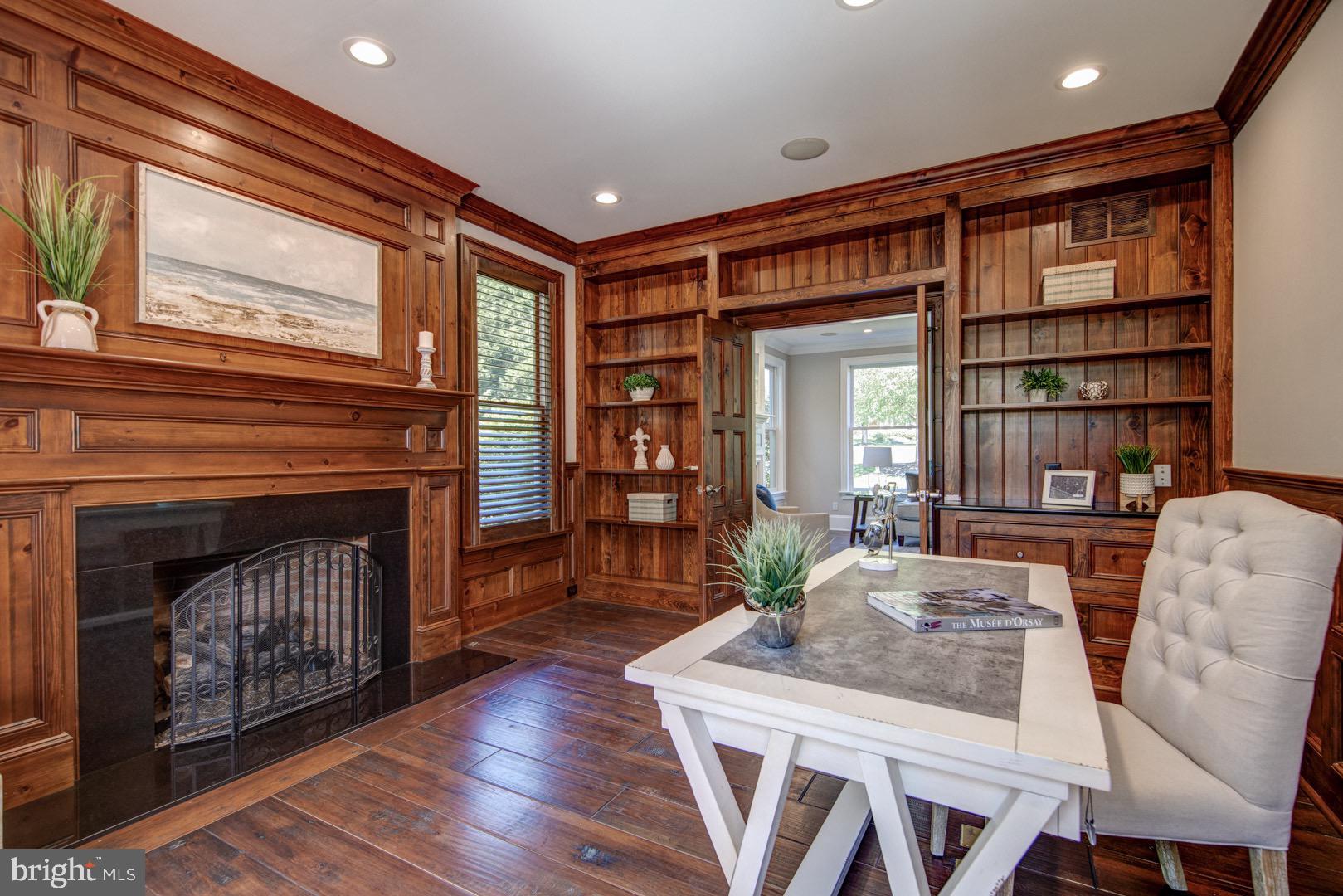 121 Brooke Farm Road Wayne, PA 19087 - Photo 19 of 46 a living room with furniture a fireplace and a bookshelf