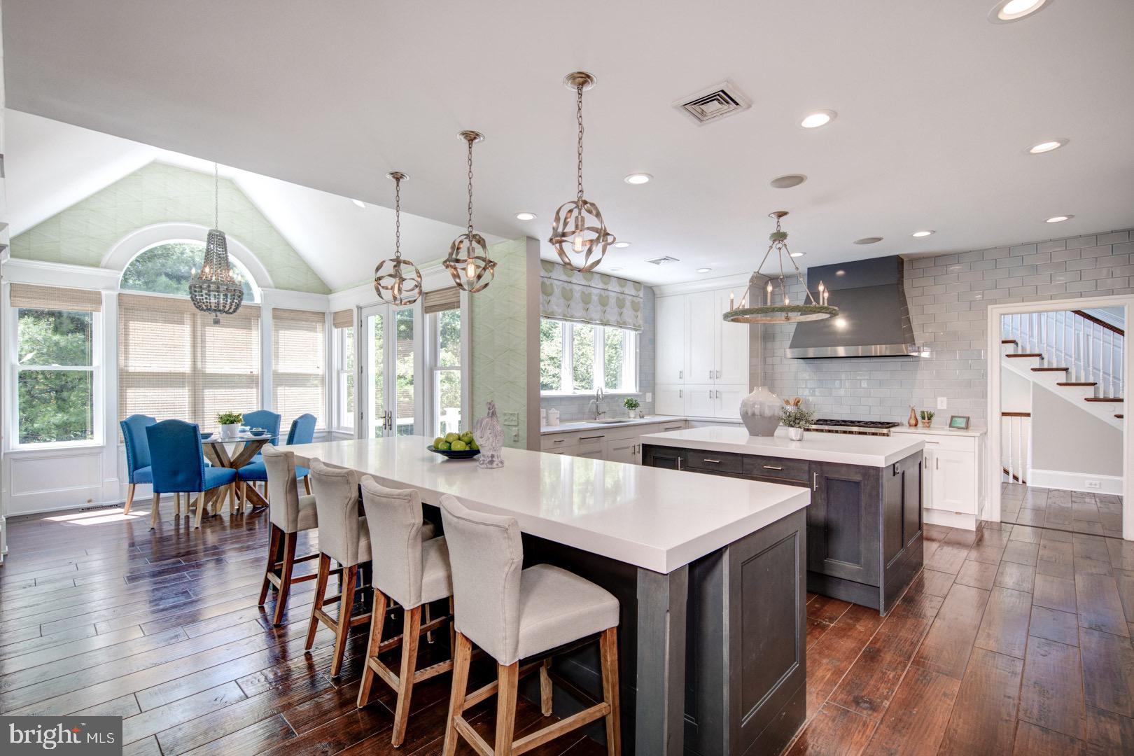 121 Brooke Farm Road Wayne, PA 19087 - Photo 10 of 46 a kitchen with stainless steel appliances granite countertop a table chairs stove and wooden floor