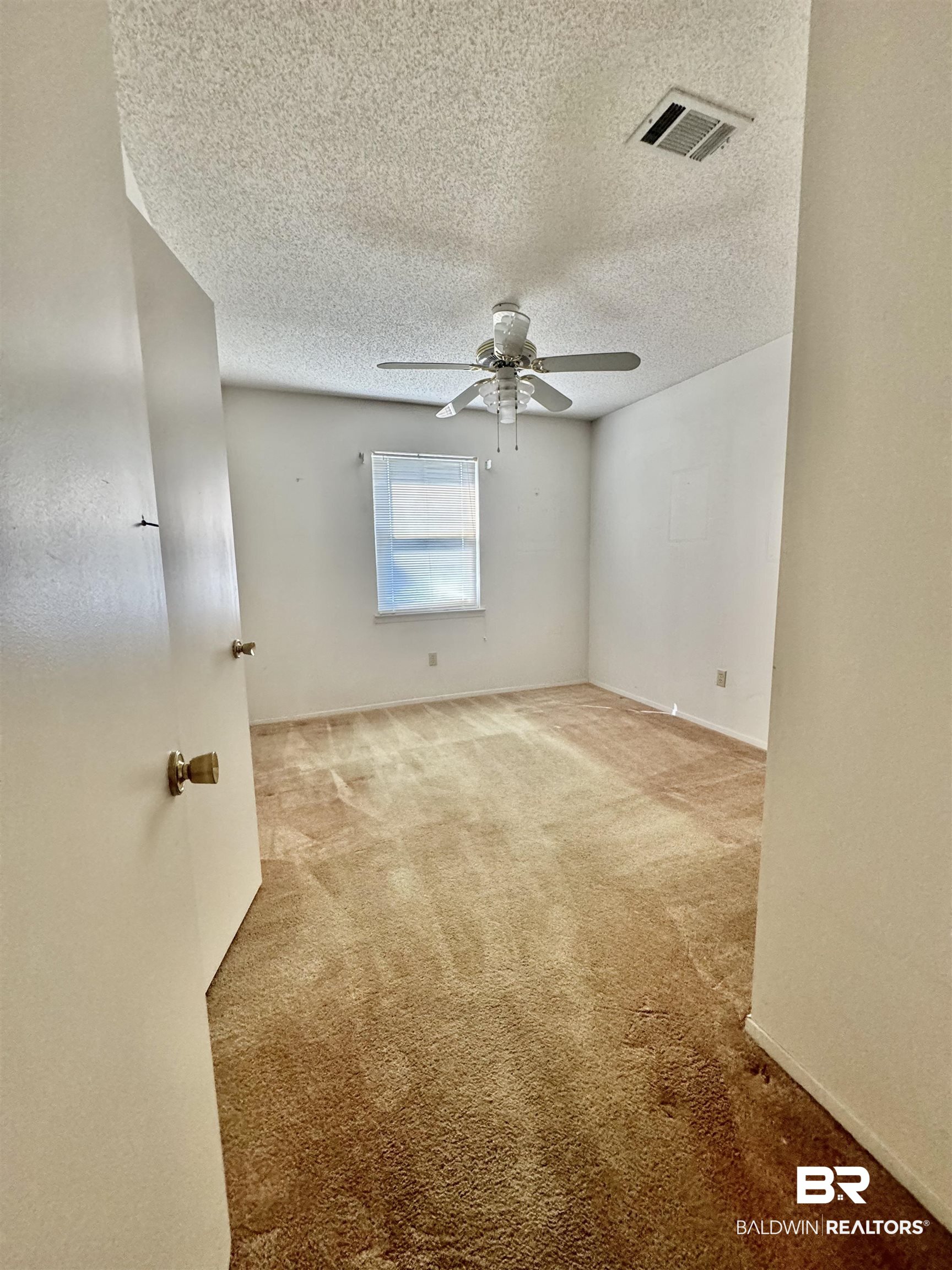 512 Deborah Court Foley, AL 36535 - Photo 18 of 23 Carpeted spare room with a textured ceiling and ceiling fan