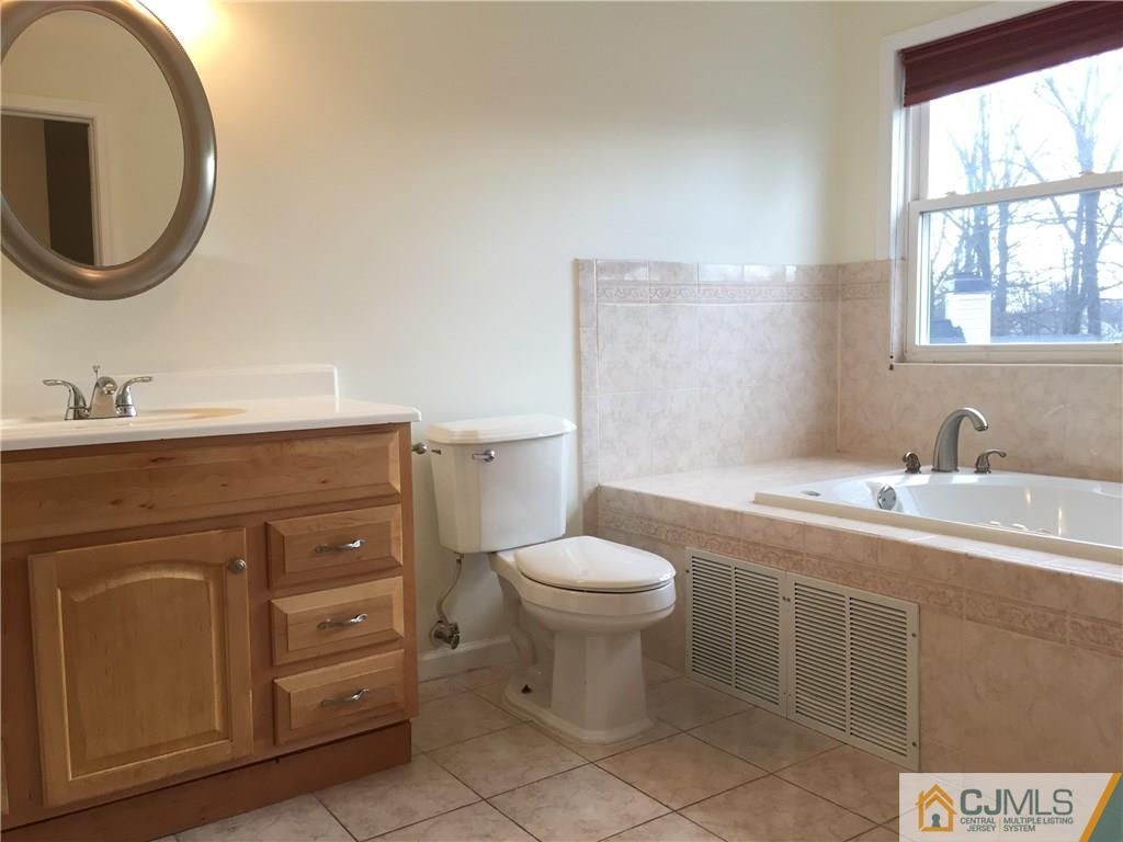 65 Idlewild Road Edison, NJ 08817 - Photo 11 of 21 a bathroom with a toilet sink and mirror