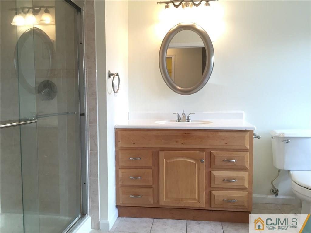 65 Idlewild Road Edison, NJ 08817 - Photo 12 of 21 a bathroom with a sink and a mirror
