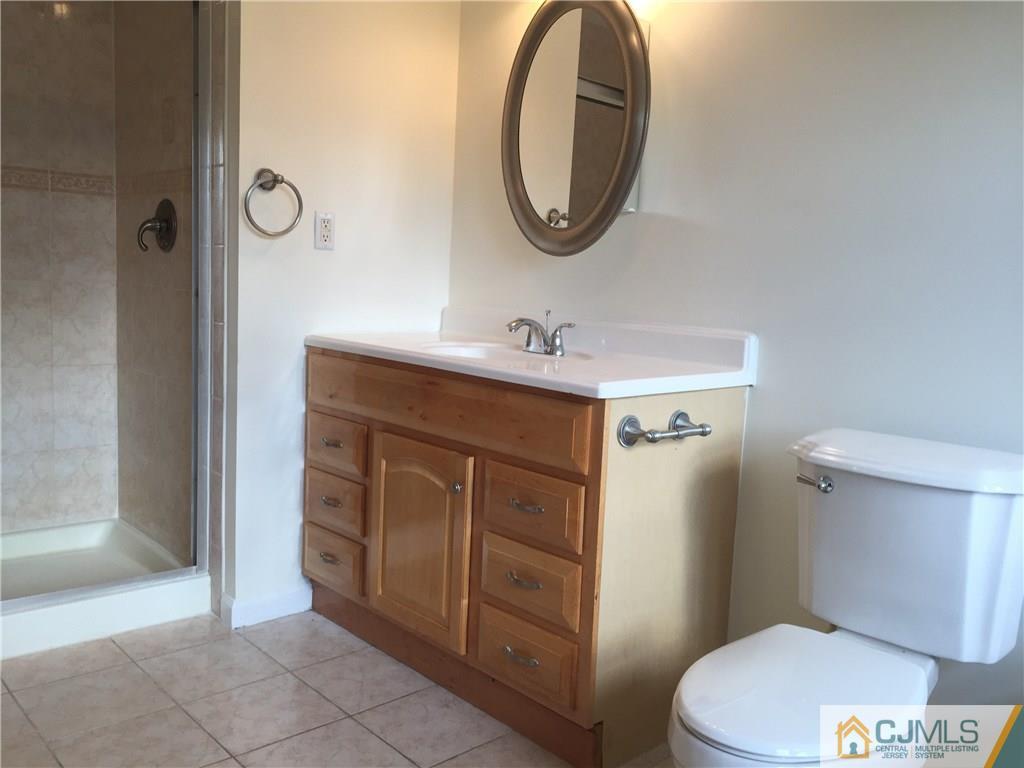 65 Idlewild Road Edison, NJ 08817 - Photo 13 of 21 a bathroom with a sink a toilet and a mirror