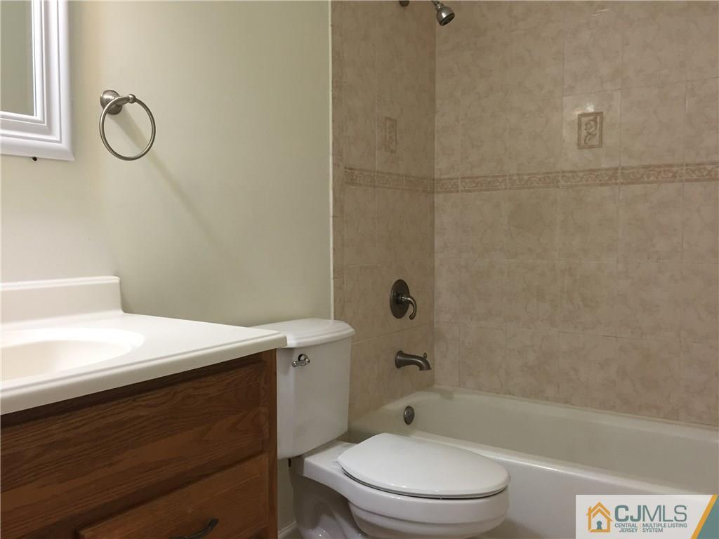 65 Idlewild Road Edison, NJ 08817 - Photo 14 of 21 a bathroom with a sink a toilet and shower