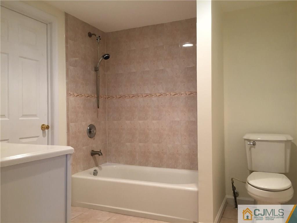65 Idlewild Road Edison, NJ 08817 - Photo 15 of 21 a bathroom with a toilet and a bathtub