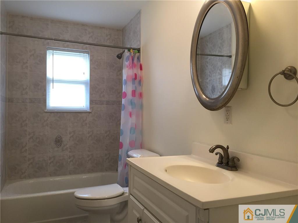 65 Idlewild Road Edison, NJ 08817 - Photo 16 of 21 a bathroom with a sink a toilet and a mirror
