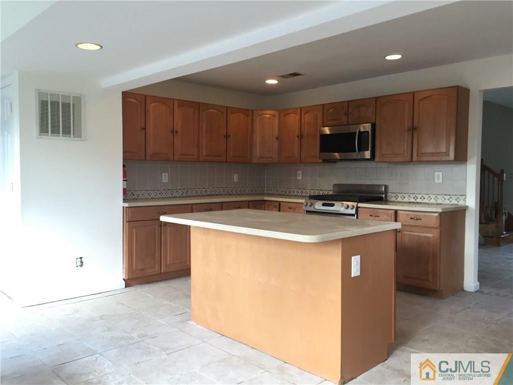 65 Idlewild Road Edison, NJ 08817 - Photo 3 of 21 a kitchen with stainless steel appliances granite countertop a stove a sink and a refrigerator