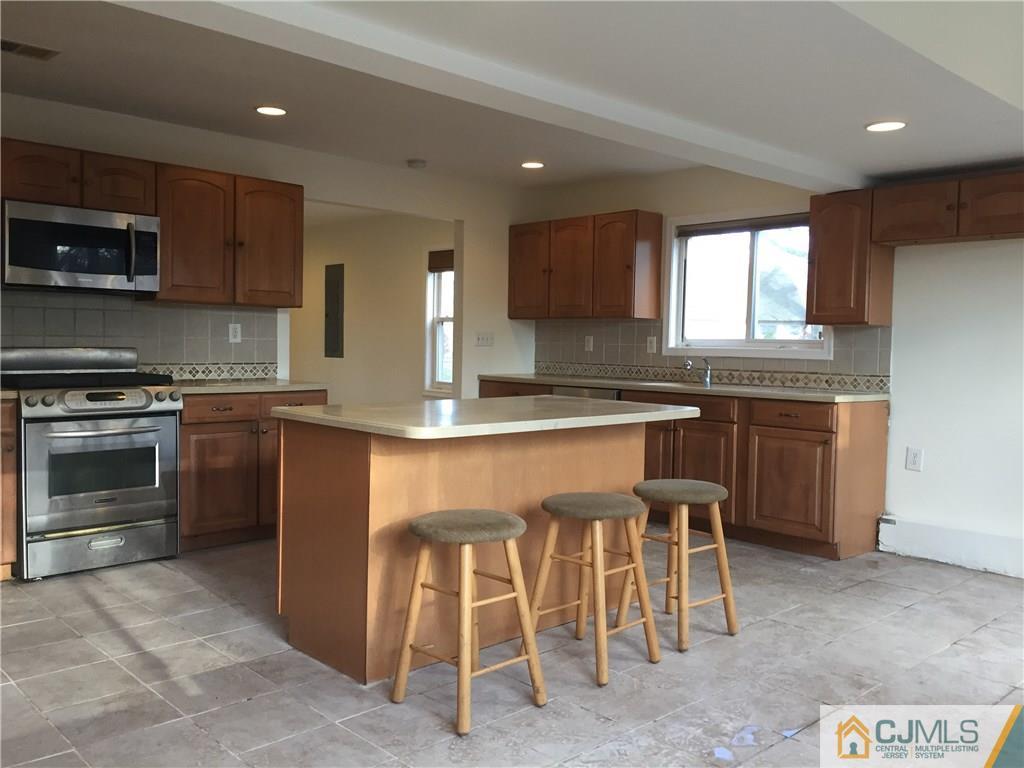 65 Idlewild Road Edison, NJ 08817 - Photo 4 of 21 a kitchen with cabinets a sink and appliances