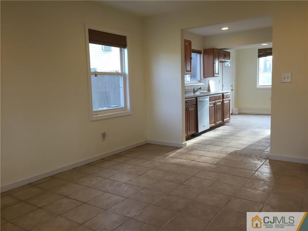 65 Idlewild Road Edison, NJ 08817 - Photo 5 of 21 a view of a kitchen with a sink stove cabinets and empty room