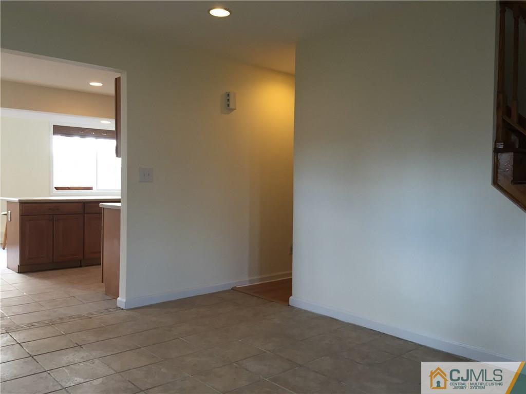 65 Idlewild Road Edison, NJ 08817 - Photo 6 of 21 an empty room with windows