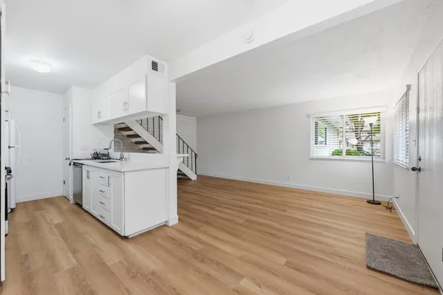 a view of kitchen with wooden floor and electronic appliances