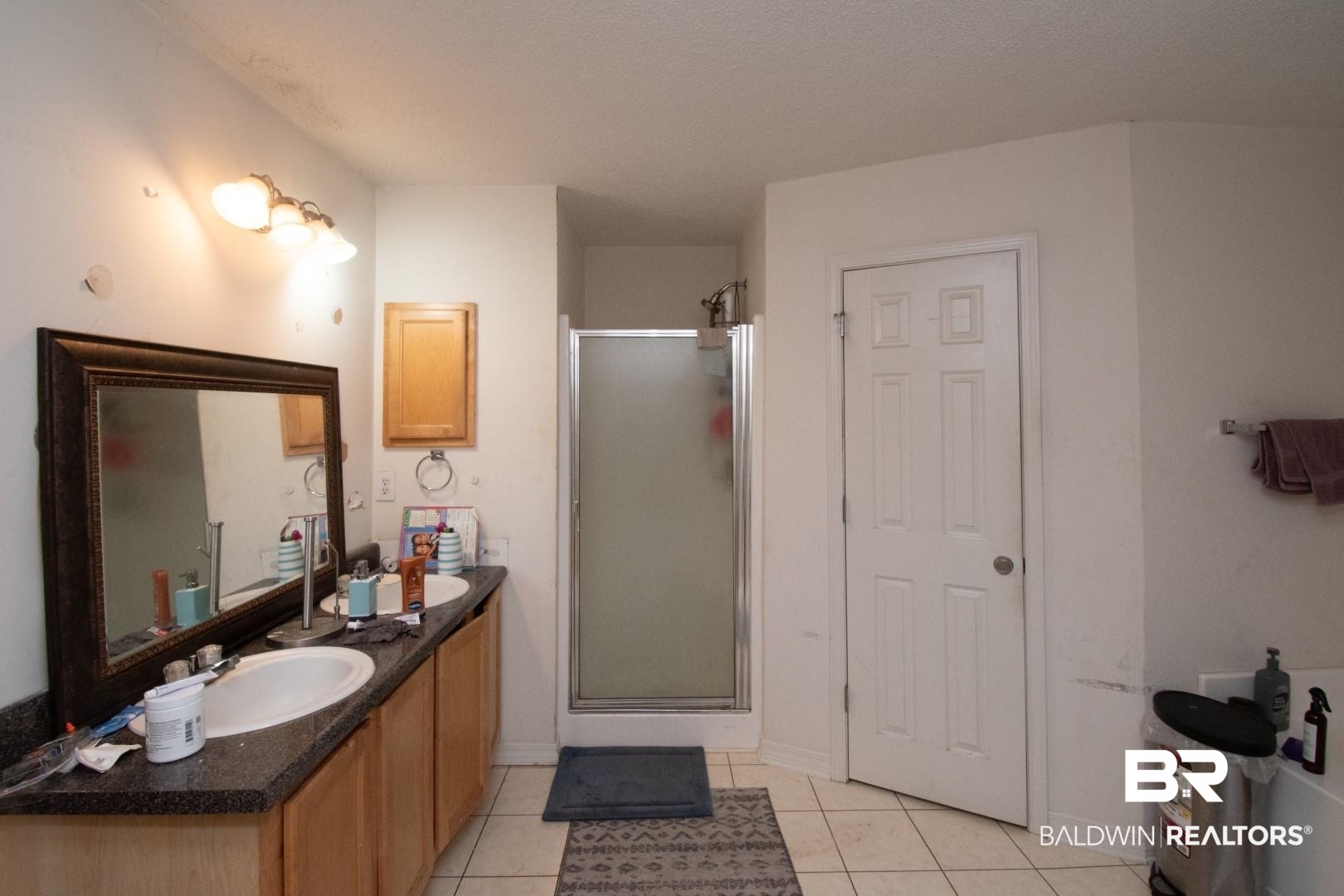 1537 Hunters Ridge Drive West Mobile, AL 36695 - Photo 10 of 12 Bathroom featuring tile patterned flooring, a shower with door, a textured ceiling, and vanity