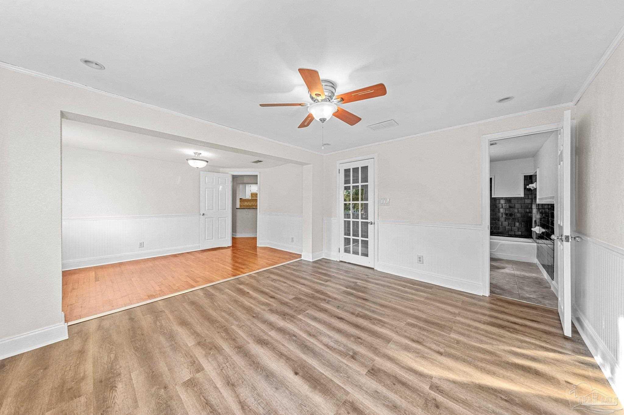 162 West Burgess Road Pensacola, FL 32503 - Photo 16 of 30 a view of empty room with wooden floor and ceiling fan