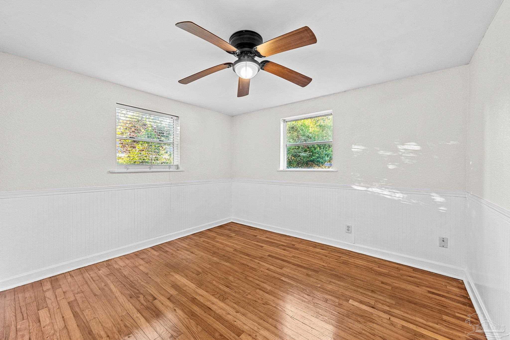 162 West Burgess Road Pensacola, FL 32503 - Photo 24 of 30 wooden floor in an empty room with a window