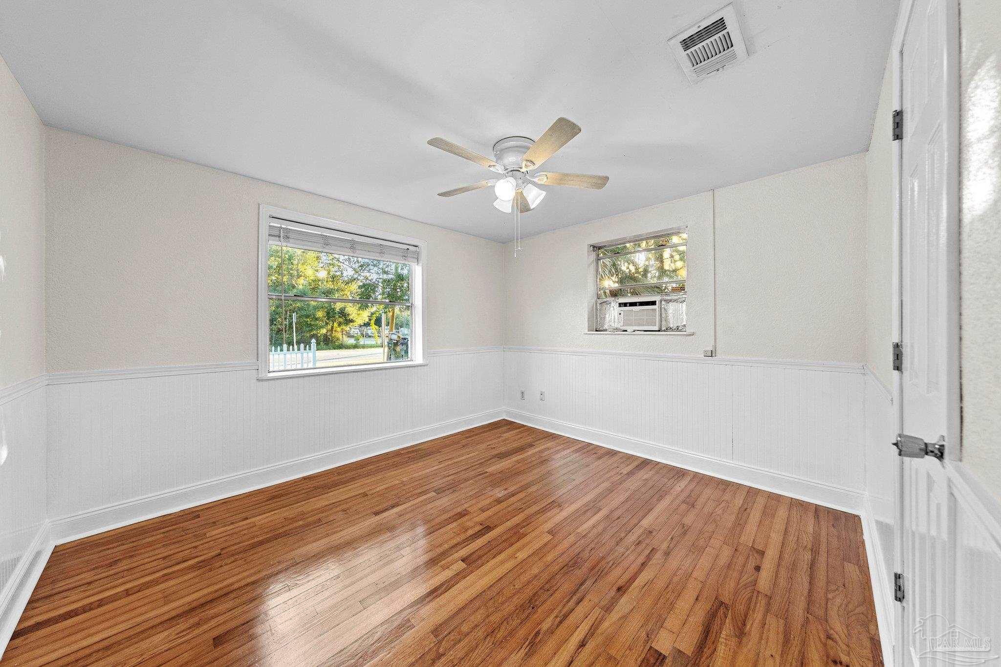 162 West Burgess Road Pensacola, FL 32503 - Photo 26 of 30 wooden floor in an empty room with a window