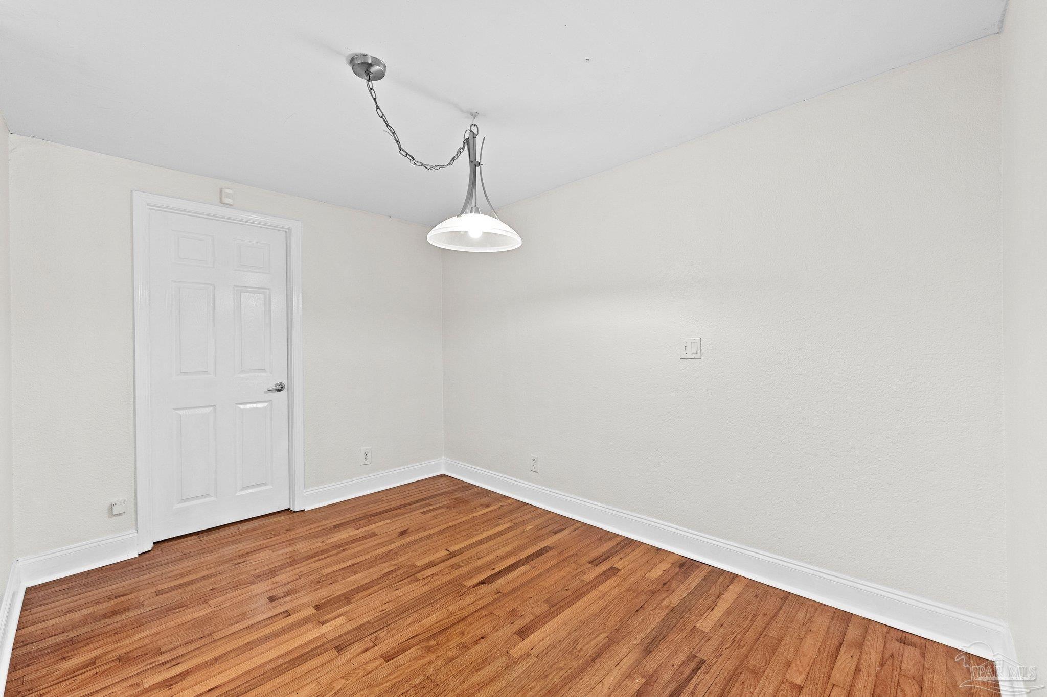 162 West Burgess Road Pensacola, FL 32503 - Photo 5 of 30 a view of a room with wooden floor and white walls