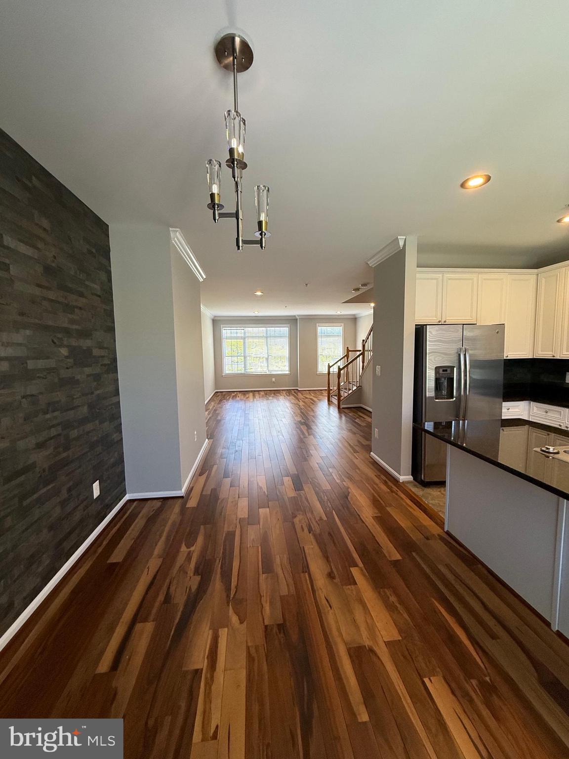 12108 Kinsley Place Reston, VA 20190 - Photo 7 of 17 a view of a room with stainless steel appliances wooden floor kitchen view and a window