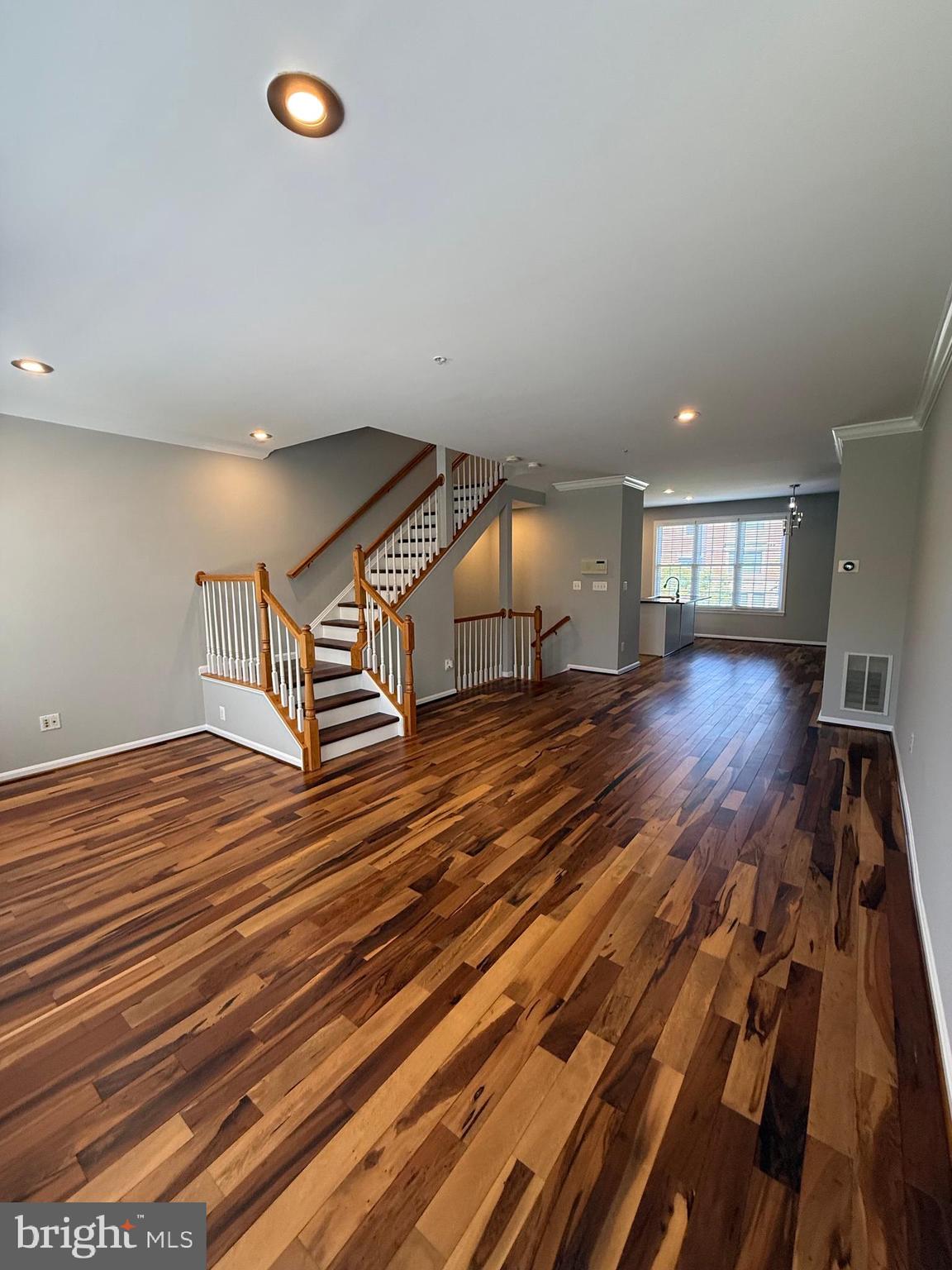 12108 Kinsley Place Reston, VA 20190 - Photo 8 of 17 a view of an empty room with wooden floor and a window