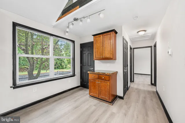 a room with wooden floor and a walk in closet