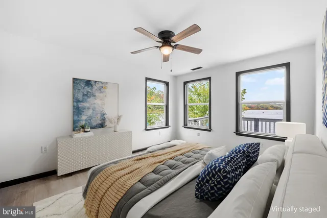 a view of wooden floor and chandelier fan in a room