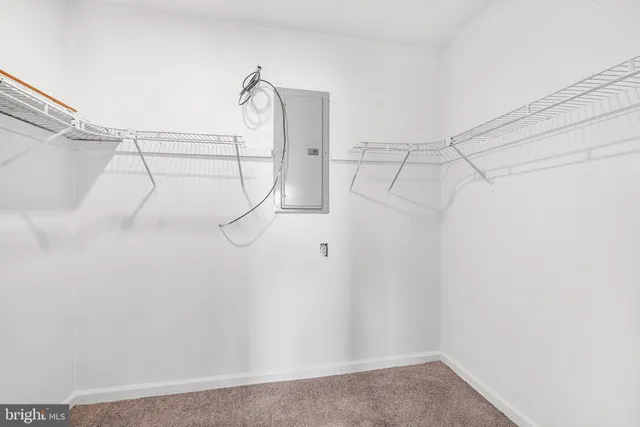 an empty room with a chandelier fan and a ceiling fan