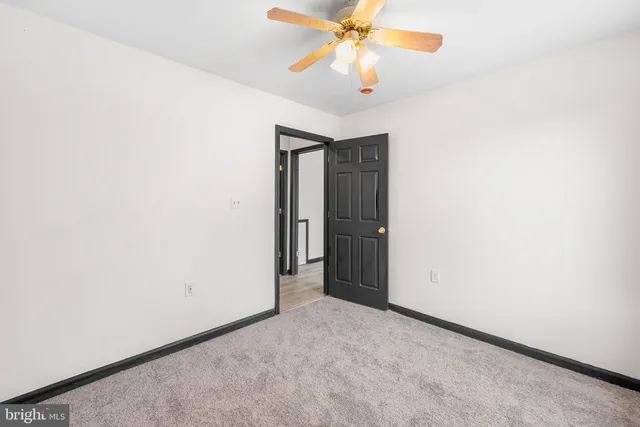 wooden floor in an empty room and a bathroom