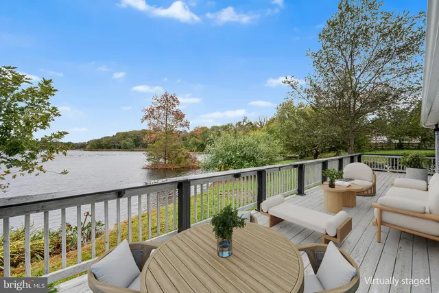 a view of roof deck with wooden floor and seating space