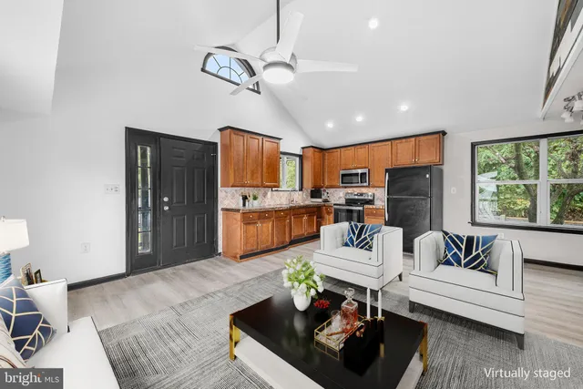 a living room with furniture fireplace and a large window