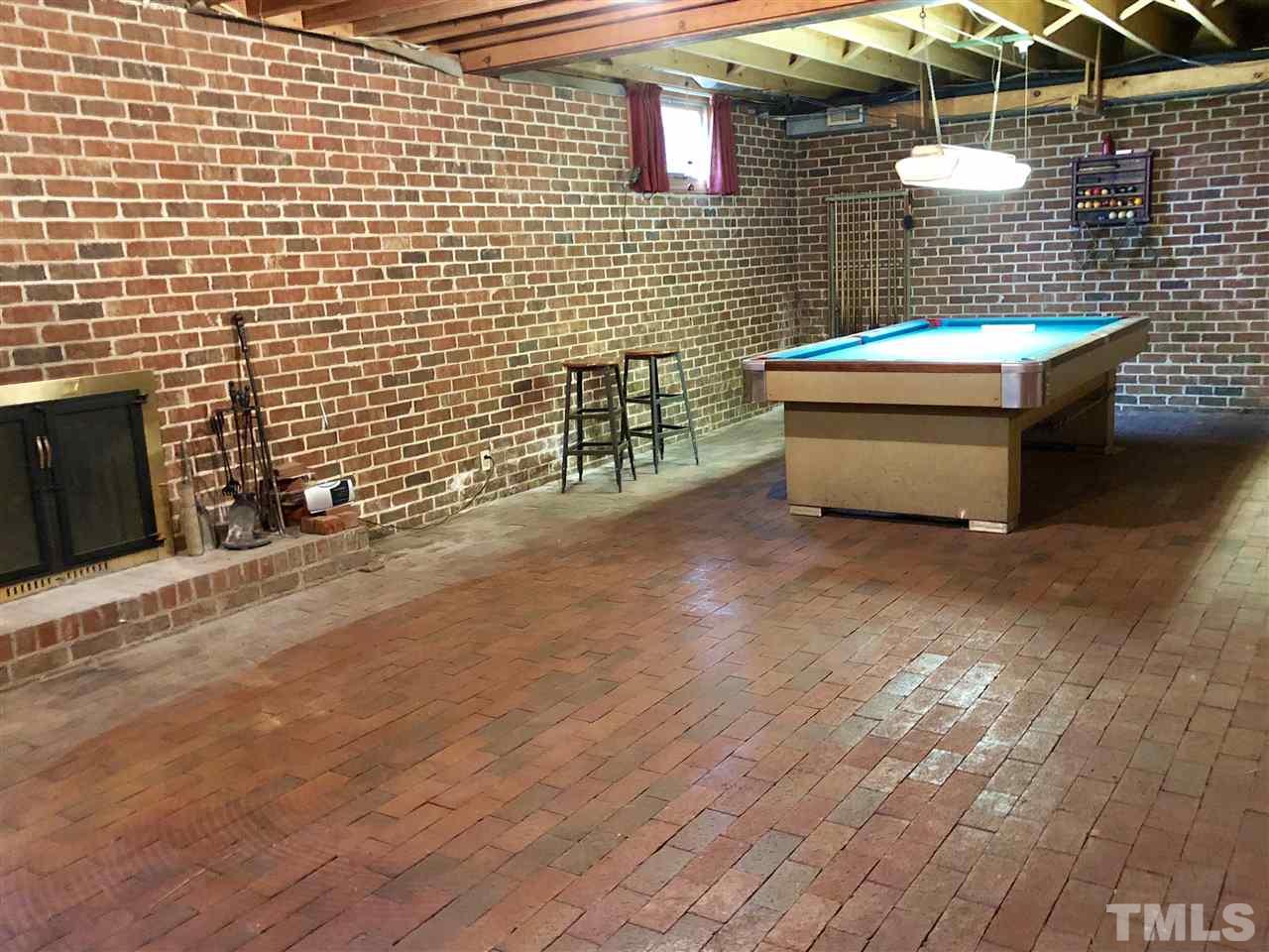 2717 Riddick Drive Raleigh, NC 27609 - Photo 9 of 13 Full basement has brick floors! Large room with pool table, wood-burning fireplace. There is a second large room, bedroom, full bath, workshop
